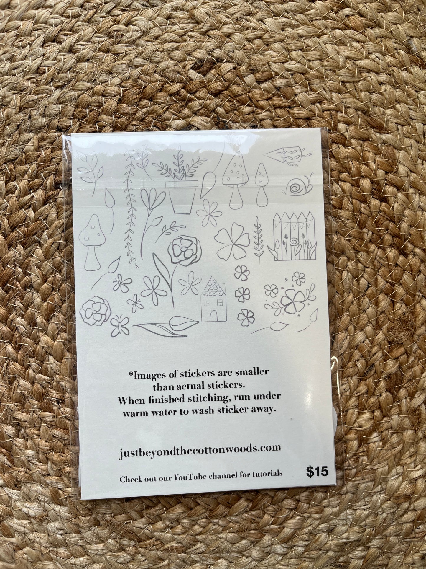 Cottage vibes pattern stickers of mushrooms, plants, cottage, fence package on woven mat